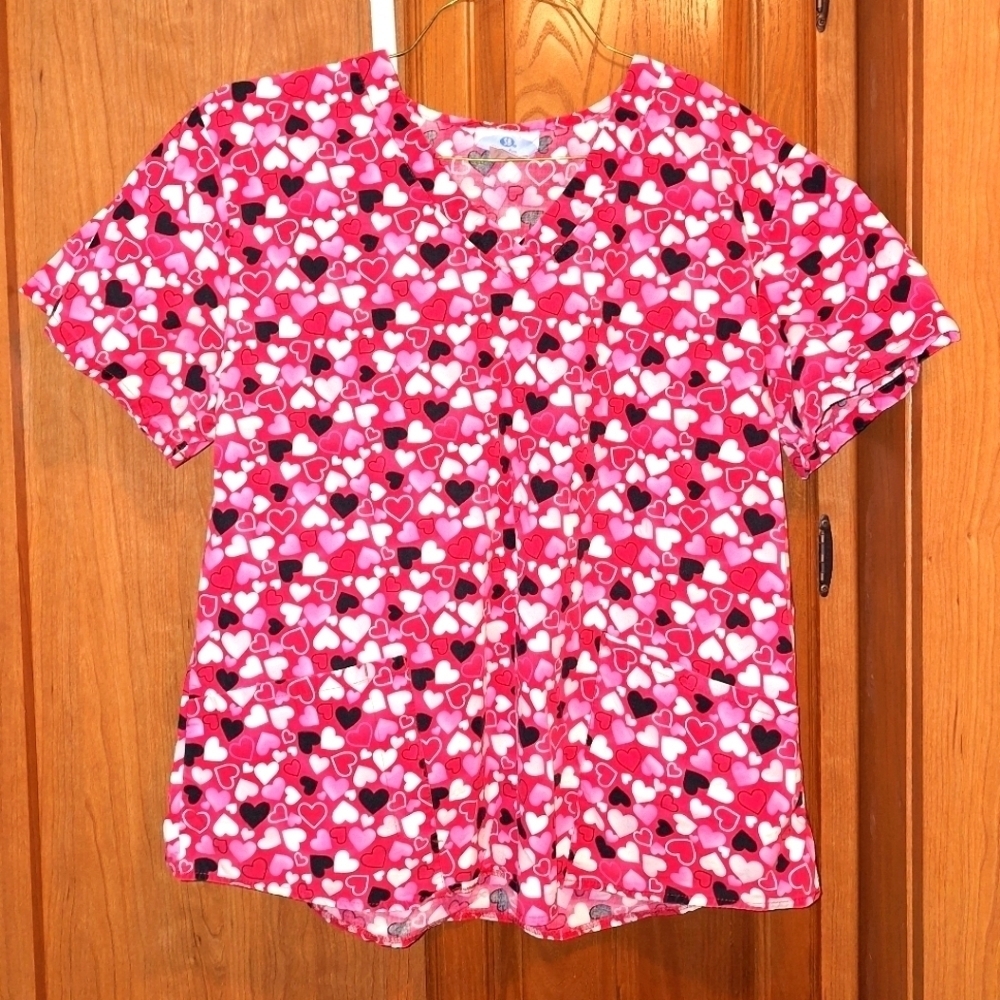SB Scrubs in a size large. It features black, pink, and white hearts on red top.